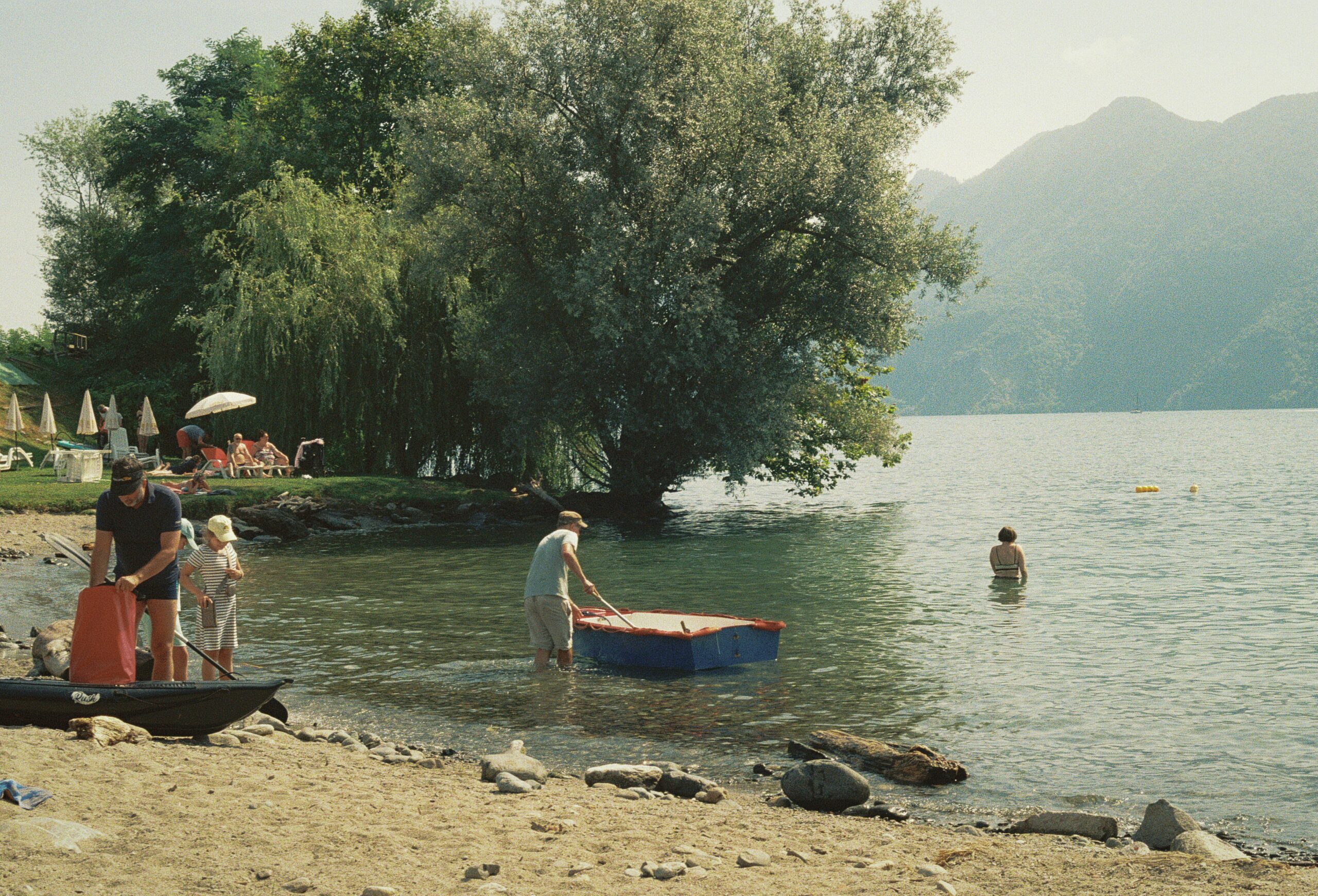 family on a beach in lake como